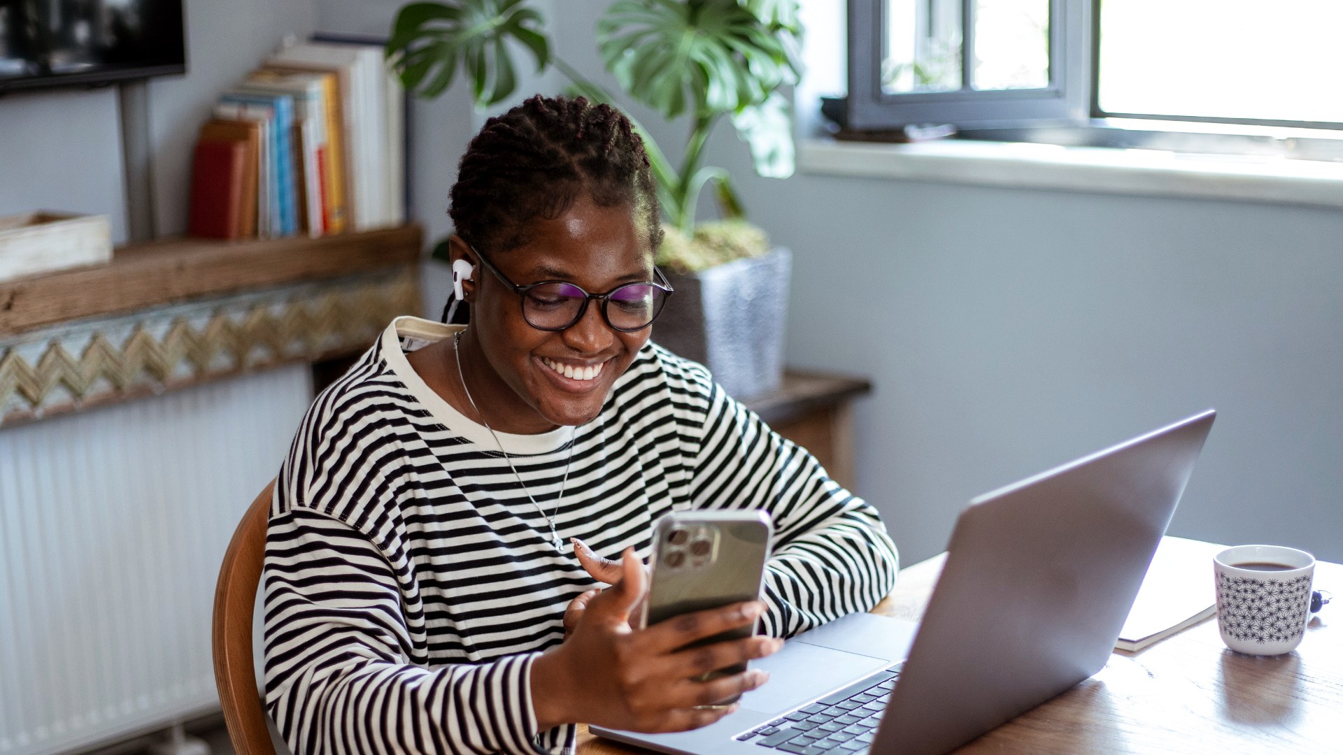 A programme participant working remotely from home on her laptop and phone